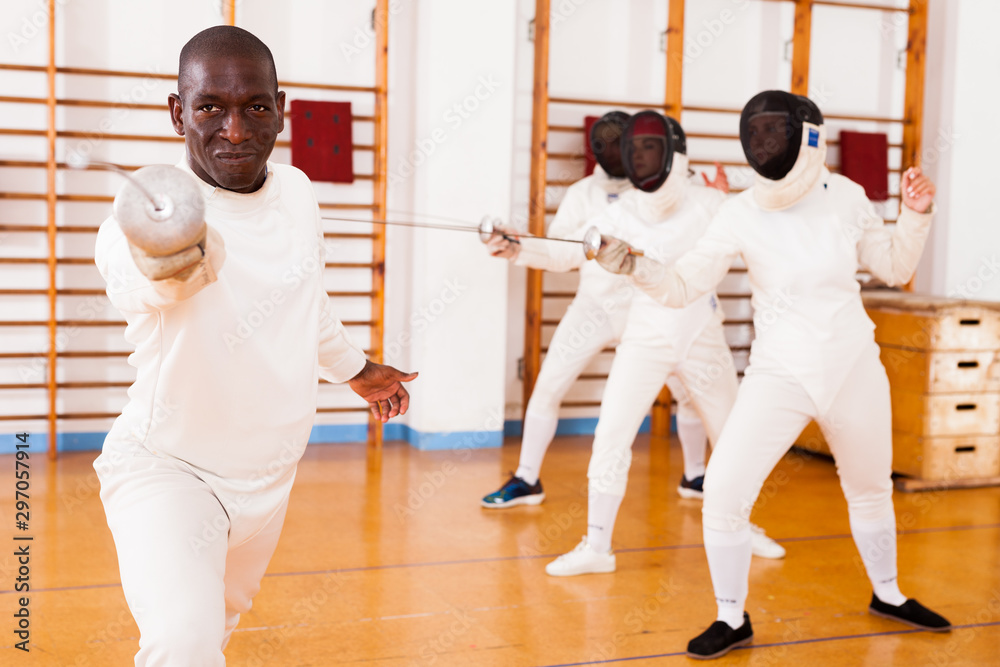 Sporty african american man fencer practicing effective fencing techniques