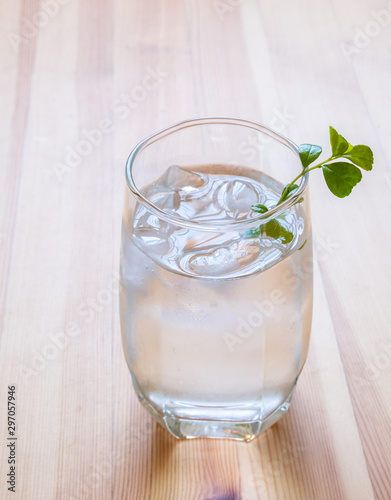 glass of cold water on wooden table