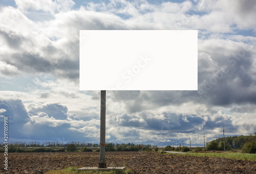 Billboard with empty place for writing text on field and sky background.