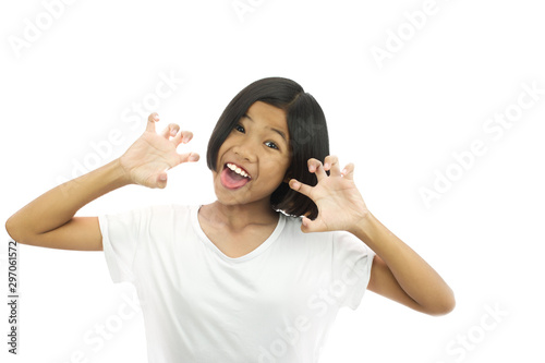 Funny crazy playful child girl in white T-shirt  making silly monkey face tiger hands. She having fun and foolish mood pose on white studio background. copy space , isolated on white background. photo