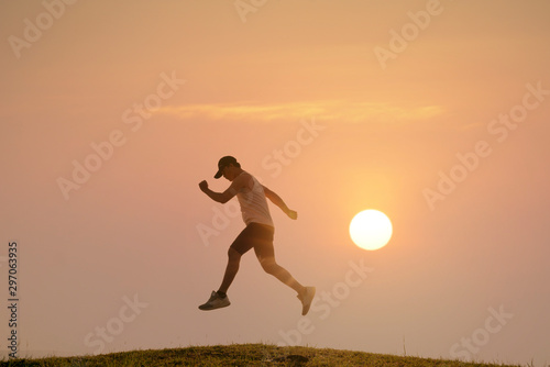 runner on rural track with sunset or sunrise, sport and healthy concept