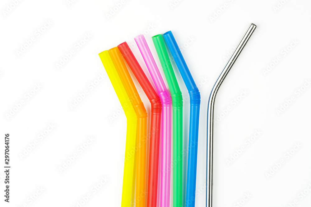 Group of colorful straw in one direction and one reusable straw pointing in different way. Innovative solutions to environmental problems , conceptual concept of save the earth by to end plastic waste Group of colorful straw in one direction and one reusable straw pointing in different way. Innovative solutions to environmental problems , conceptual concept of save the earth by to end plastic waste