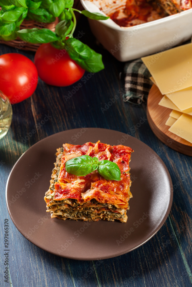 Piece of tasty hot lasagna with spinach on a plate Piece of tasty hot lasagna with spinach on a plate