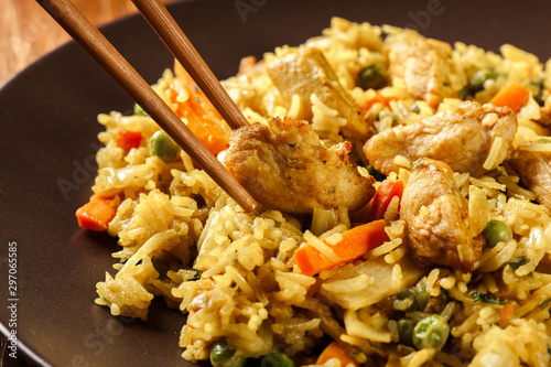 Konstfotografi Fried rice nasi goreng with chicken and vegetables on a plate