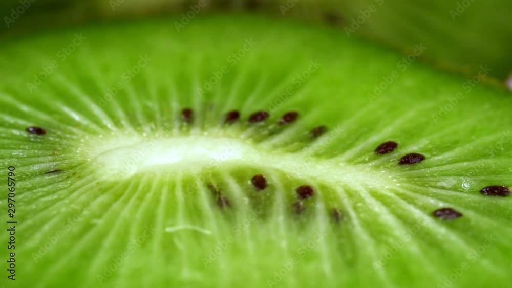Slow motion and macro shot of a water drop fallin on kiwi slice. Healthy food Slow motion and macro shot of a water drop fallin on kiwi slice. Healthy food