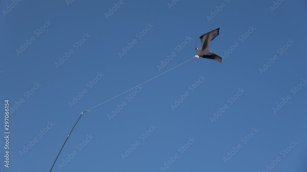 Black decorative cloth bird on sky background in wind, toy bird Black decorative cloth bird on sky background in wind, toy bird