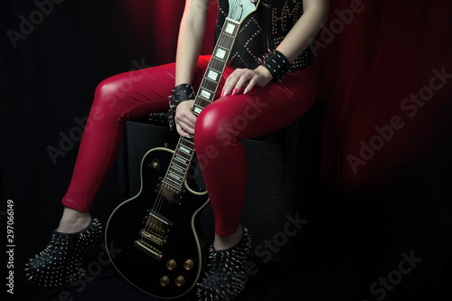 Guitarist.Closeup of electrical guitar fingerboard.Hand of rocker in leather  bracelet.Rock & roll, heavy metal,gothic,punk,horns sign and fist.Hard style.Rivets accessories