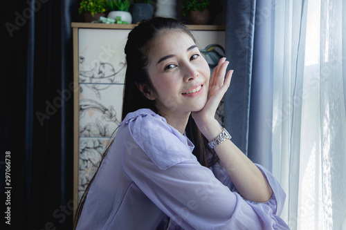 young asian woman sitting and relaxing at home.