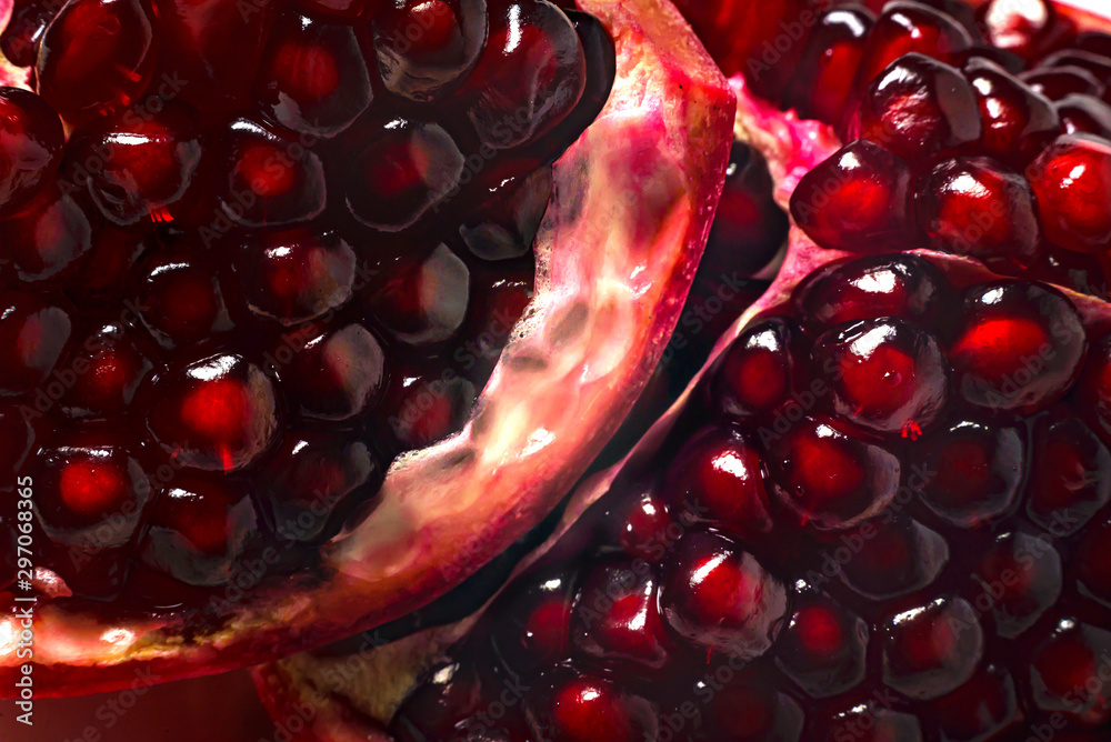 Delicious beautiful pomegranate on dark background. Close-up image of a red pomegranate - obrazy, fototapety, plakaty 