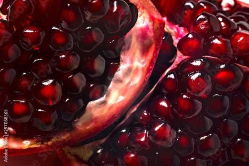 Delicious beautiful pomegranate on dark background. Close-up image of a red pomegranate