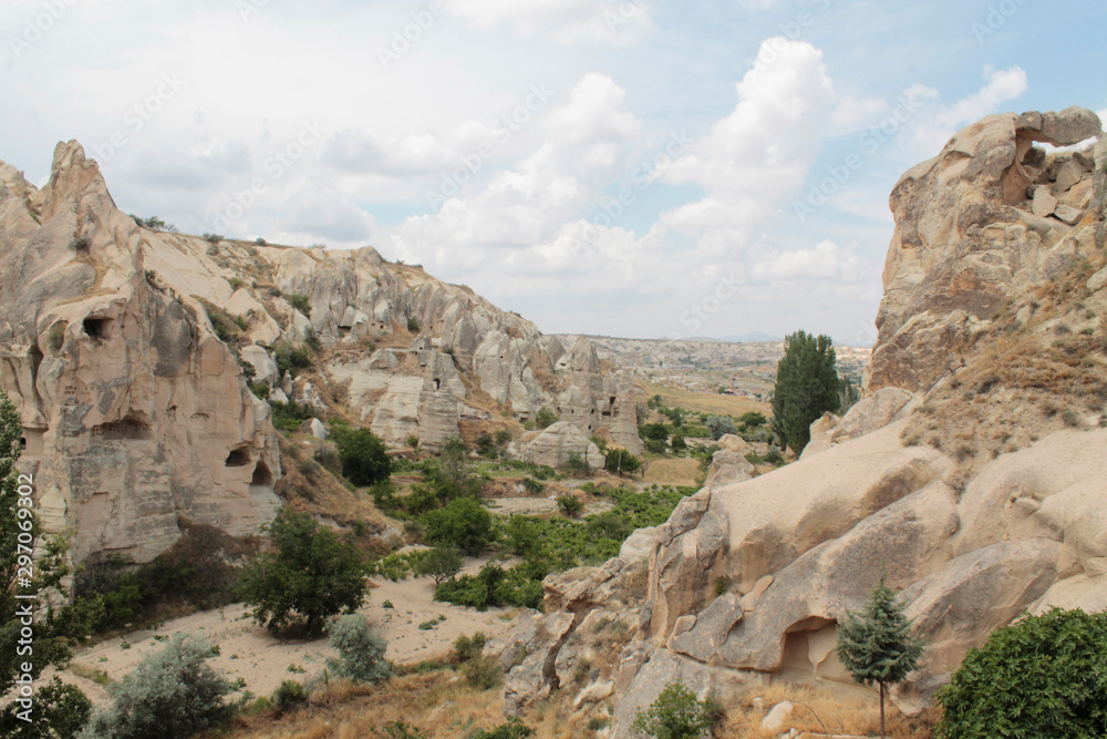 Splendid view of rocky hills surrounded by green trees in famous travel destination - Cappadocia, Turkey