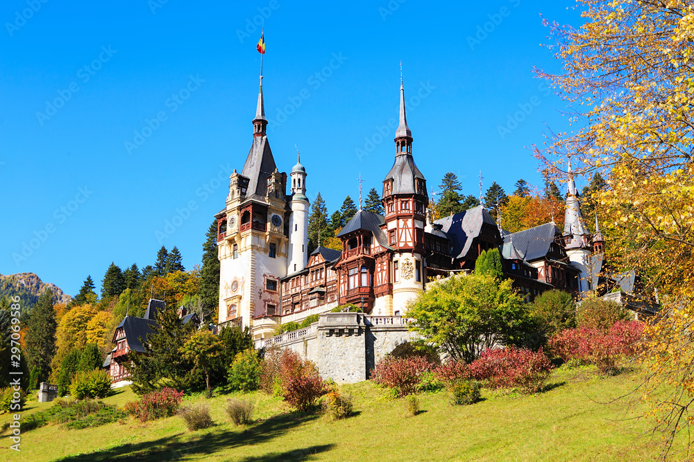 Fototapeta premium Peles Castle, Romania. Beautiful famous royal castle and ornamental garden in Sinaia landmark of Carpathian Mountains