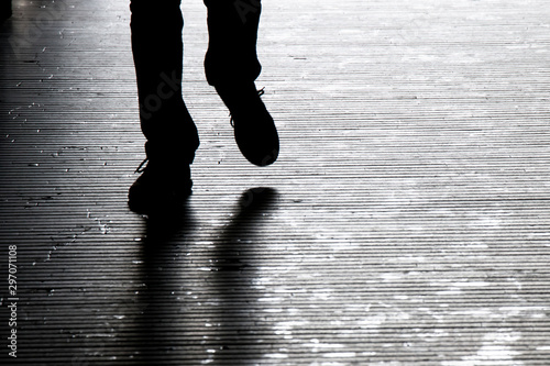Blurry shadow silhouette of a man walking in the night, detail