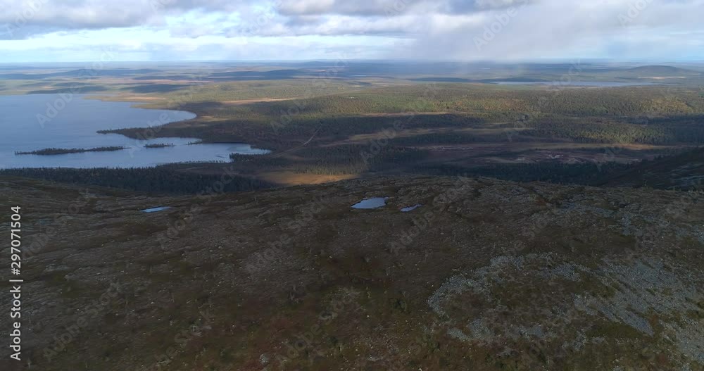 The top of a fell, Aerial, drone shot, above the rocky, Lommoltunturi fell, overlooking lake Pallasjarvi and arctic wilderness, on a autumn day, in Pallas-Yllastunturi national park, Lapland, Finland The top of a fell, Aerial, drone shot, above the rocky, Lommoltunturi fell, overlooking lake Pallasjarvi and arctic wilderness, on a autumn day, in Pallas-Yllastunturi national park, Lapland, Finland