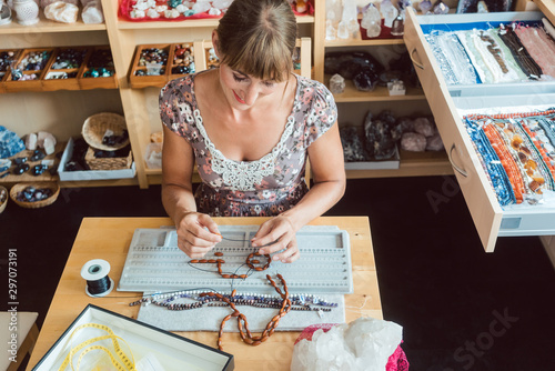 Woman working on a gemstone necklace as a hobby photo