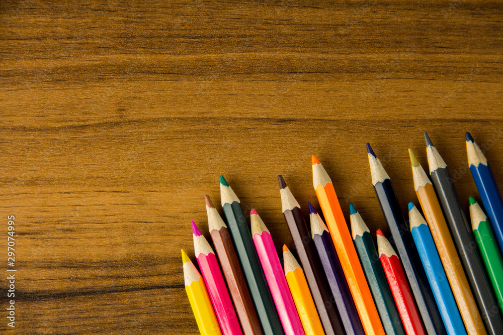 colored pencils on a brown table colored pencils on a brown table