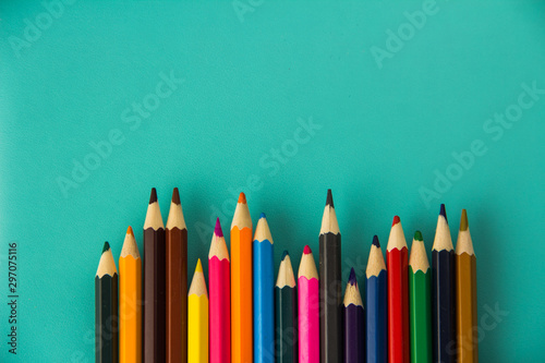 colored pencils on turquoise background