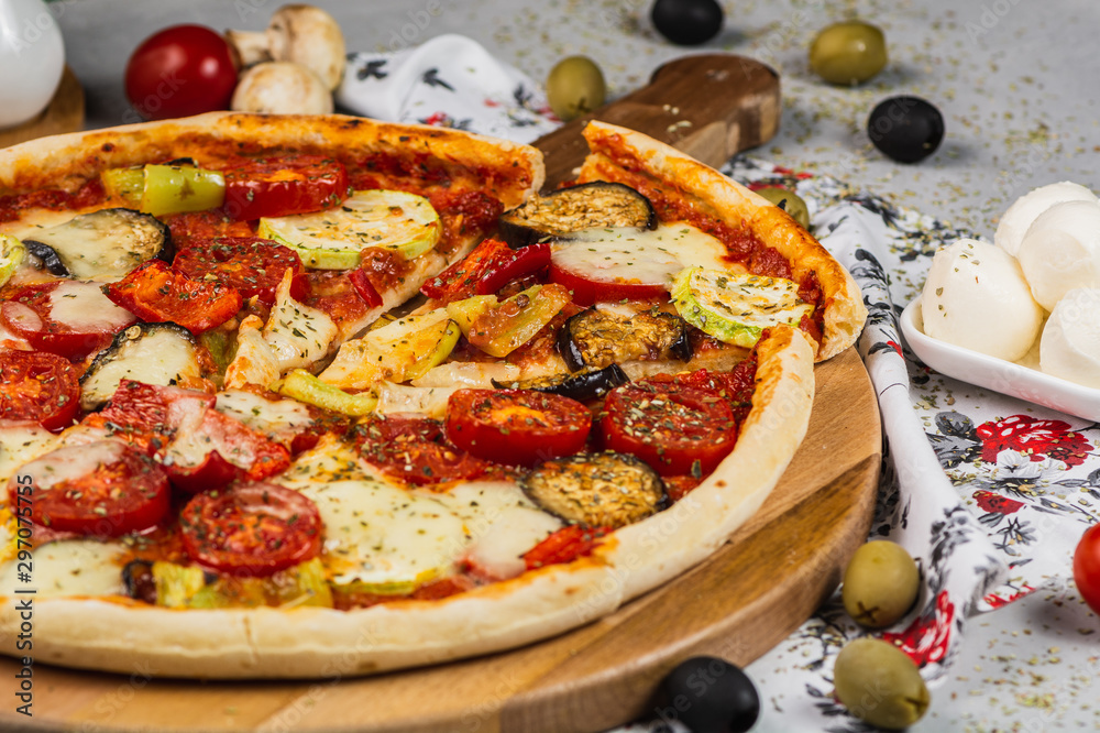 Vegetarian Pizza made with zucchini, mozzarella, pepper, eggplant and tomato.