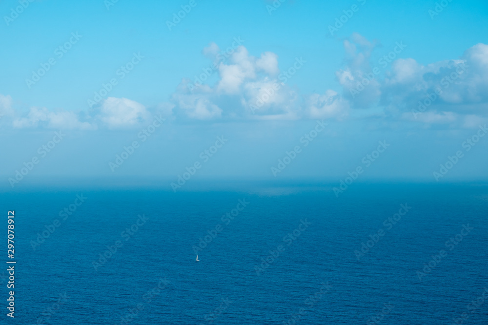 sailing boat far away on ocaen horizon, seascape aerial