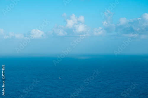 sailing boat far away on ocaen horizon, seascape aerial © hanohiki