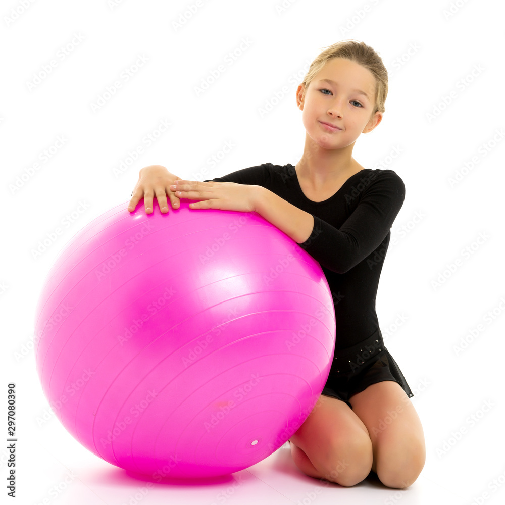little girl doing exercises on a big ball for fitness. little girl doing exercises on a big ball for fitness.