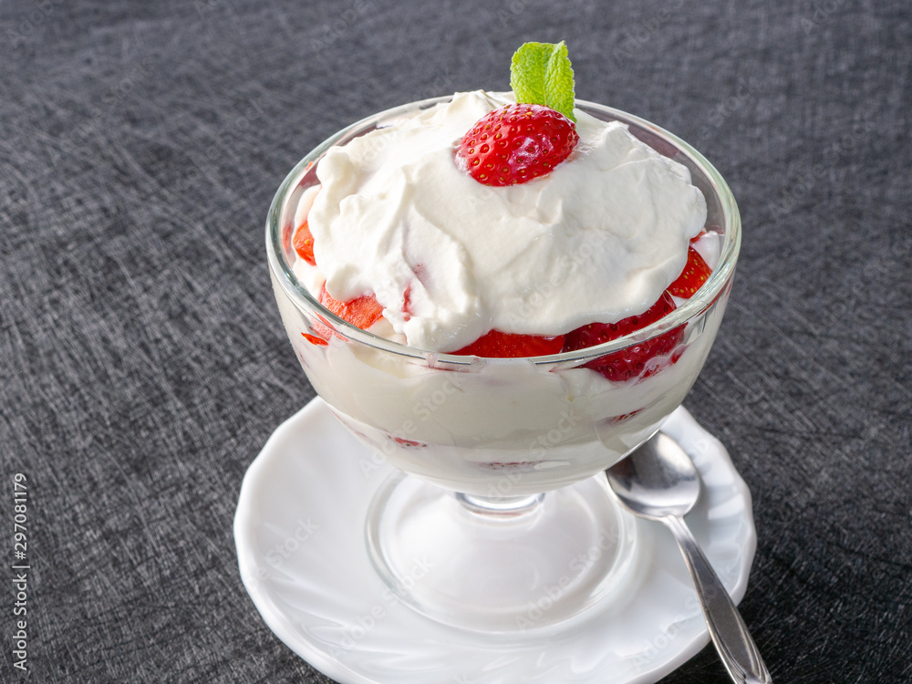Strawberries with whipped cream in a glass bowl Strawberries with whipped cream in a glass bowl