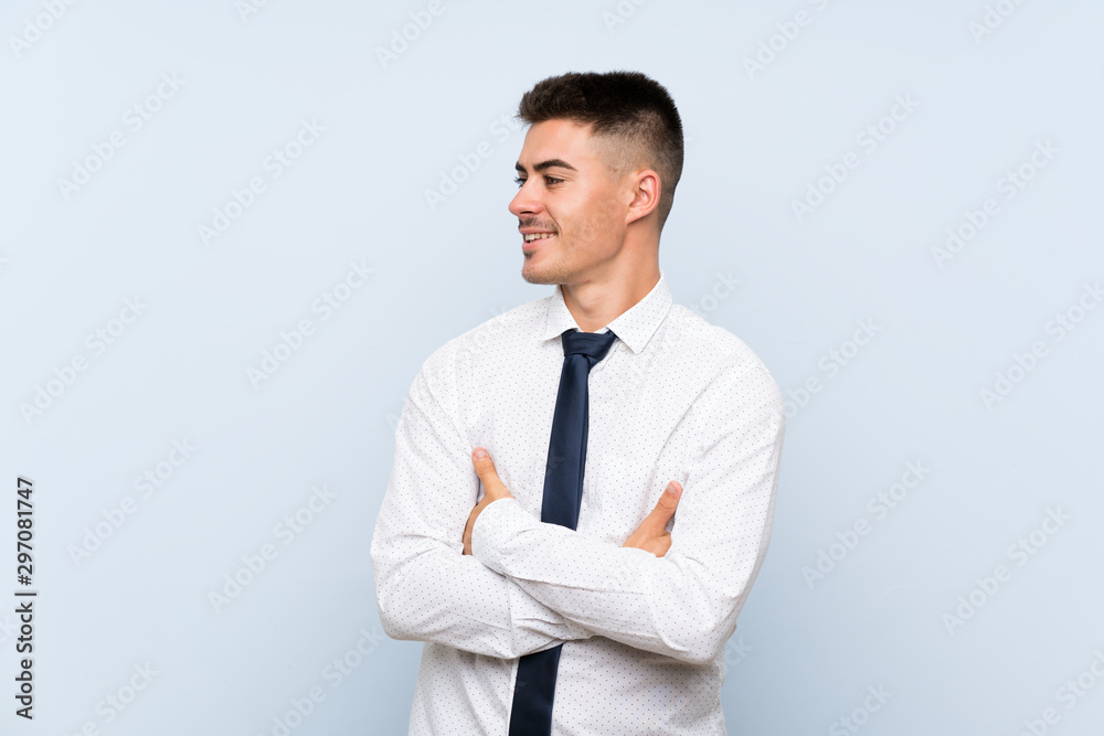 Handsome businessman over isolated blue background looking to the side Handsome businessman over isolated blue background looking to the side