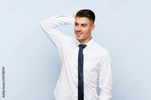 Handsome businessman over isolated blue background laughing