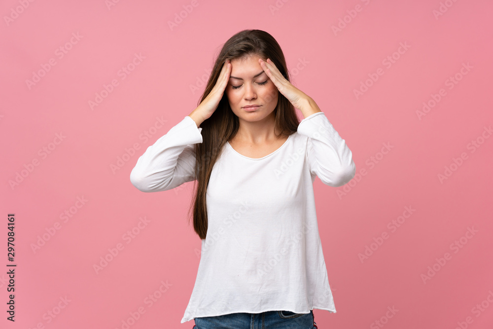 Young woman over isolated pink background with headache Young woman over isolated pink background with headache