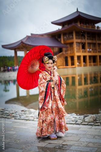 Young women wearing traditional Japanese Kimono at Japanese castle © Morakot