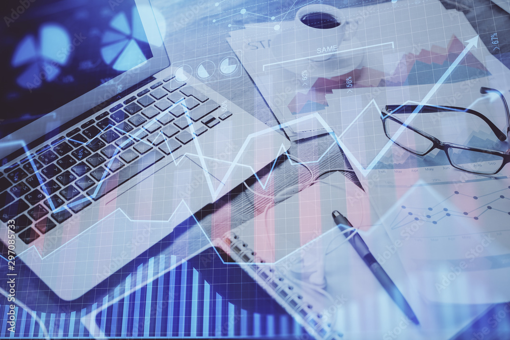 Forex market chart hologram and personal computer background. Multi exposure. Concept of investment. Forex market chart hologram and personal computer background. Multi exposure. Concept of investment.