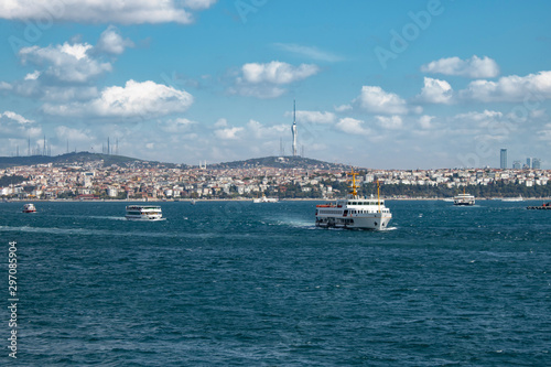 In Istanbul, ferries operate on the Bosphorus line. Traditional old steamers. Cloud weather in the background and the Anatolian side.