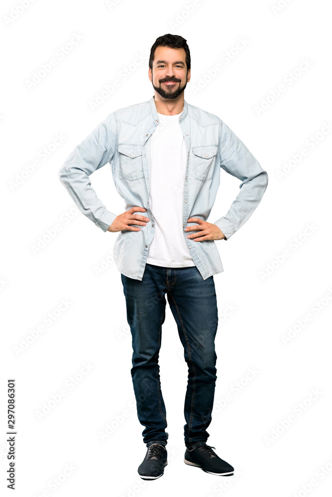 Full-length shot of Handsome man with beard posing with arms at hip and smiling over isolated white background Full-length shot of Handsome man with beard posing with arms at hip and smiling over isolated white background
