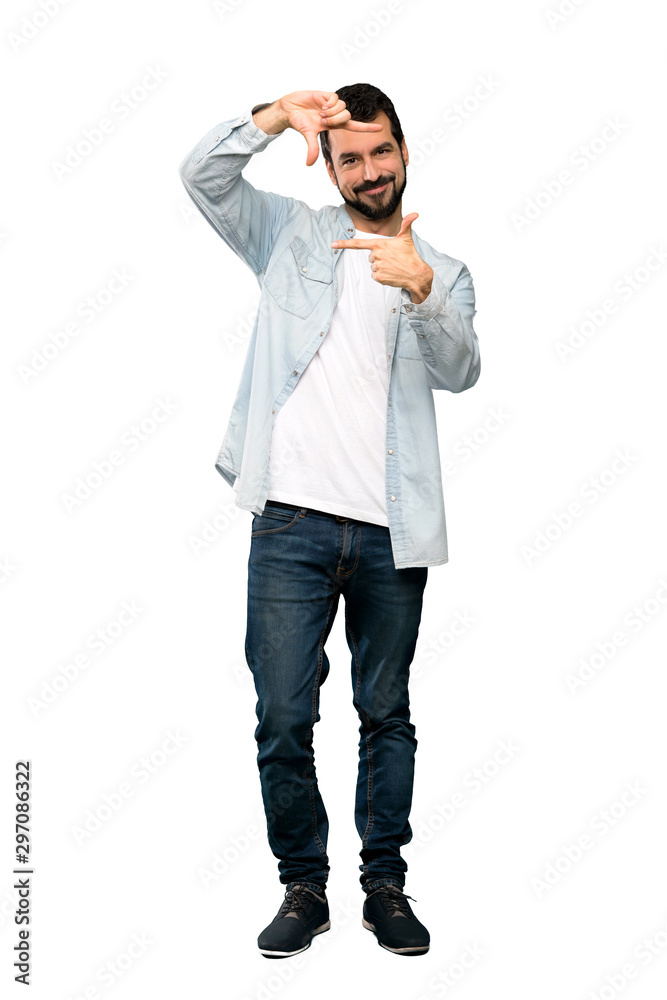 Full-length shot of Handsome man with beard focusing face. Framing symbol over isolated white background Full-length shot of Handsome man with beard focusing face. Framing symbol over isolated white background