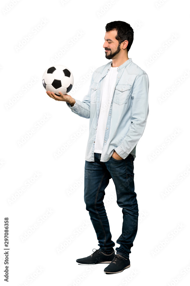 Fototapeta premium Handsome man with beard holding a soccer ball