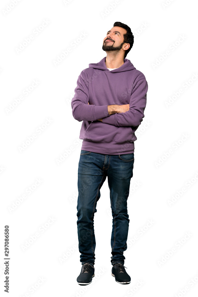 Full-length shot of Handsome man with sweatshirt looking up while smiling over isolated white background Full-length shot of Handsome man with sweatshirt looking up while smiling over isolated white background
