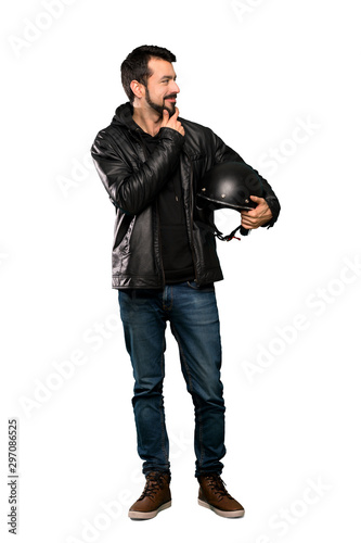 Full-length shot of Biker man looking to the side over isolated white background