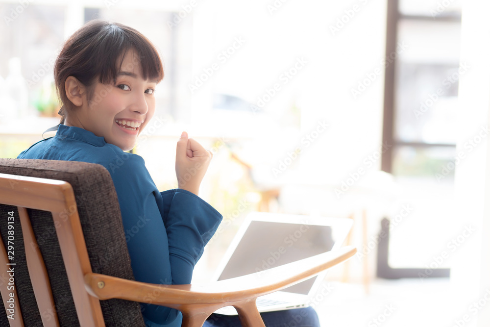 Back view beautiful of portrait happy young freelance asian woman using laptop work with success in the home, asia girl and notebook shopping online with glad, communication concept. Back view beautiful of portrait happy young freelance asian woman using laptop work with success in the home, asia girl and notebook shopping online with glad, communication concept.