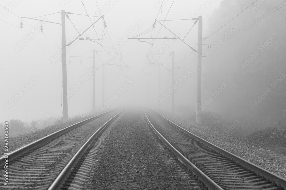 Close-up rails going far into the distance on a foggy morning. Close-up rails going far into the distance on a foggy morning.
