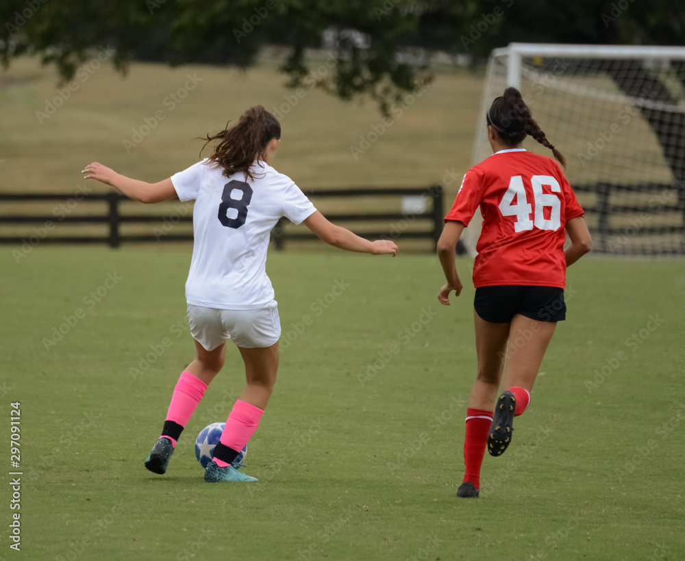 Soccer players of opposing teams