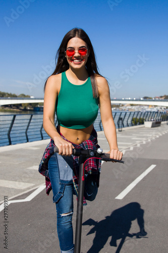 Pretty young woman riding a...