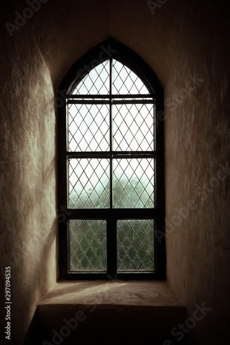 Ancient castle window. Vintage gothic style photo.