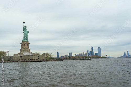 USA, New York - May 2019: Statue of Liberty, Liberty Island, with Manhtattan in the background