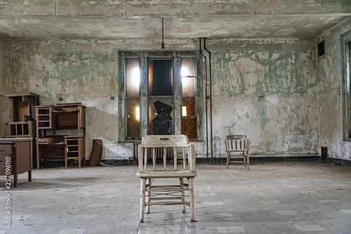 USA, New York, Ellis Island - May 2019: Old furniture abandoned in a derelict building