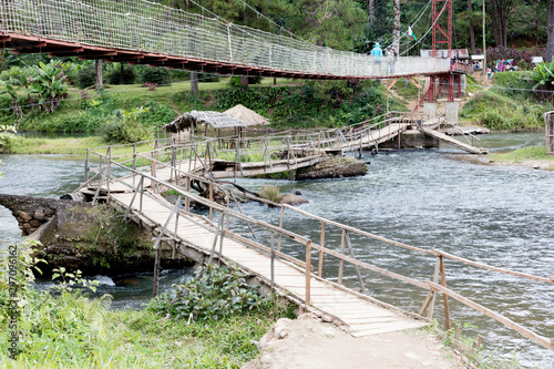 Ranomafana, Madagascar on july 28, 2019 - Instable old wooden bridge over a river, roadway for the local people on Ranomafana, Madagascar photo