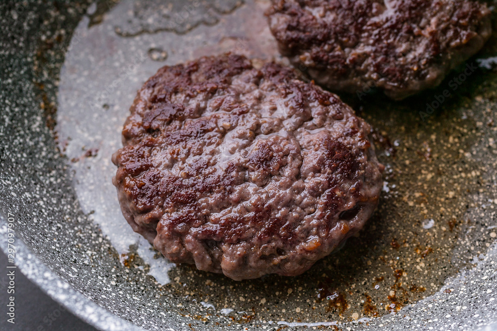 Close-up two appetizing juicy burger on a ceramic pan. Close-up two appetizing juicy burger on a ceramic pan.