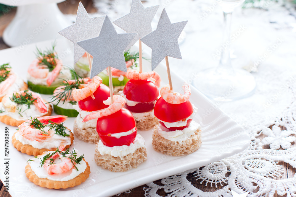 Assorted appetizers canapes with shrimps - with fresh cucumbers, cherry tomatoes, bread, crackers on the festive table, horizontal, copy space