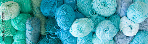 Colored balls and skiens of yarn. Top view. Aquamarine colors. Yarn for knitting.