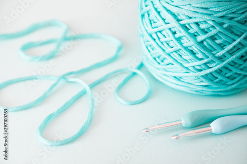 Knitting wool and knitting needles and yarn in pastel blue and aquamarine colors. top view. copy space. Close up.