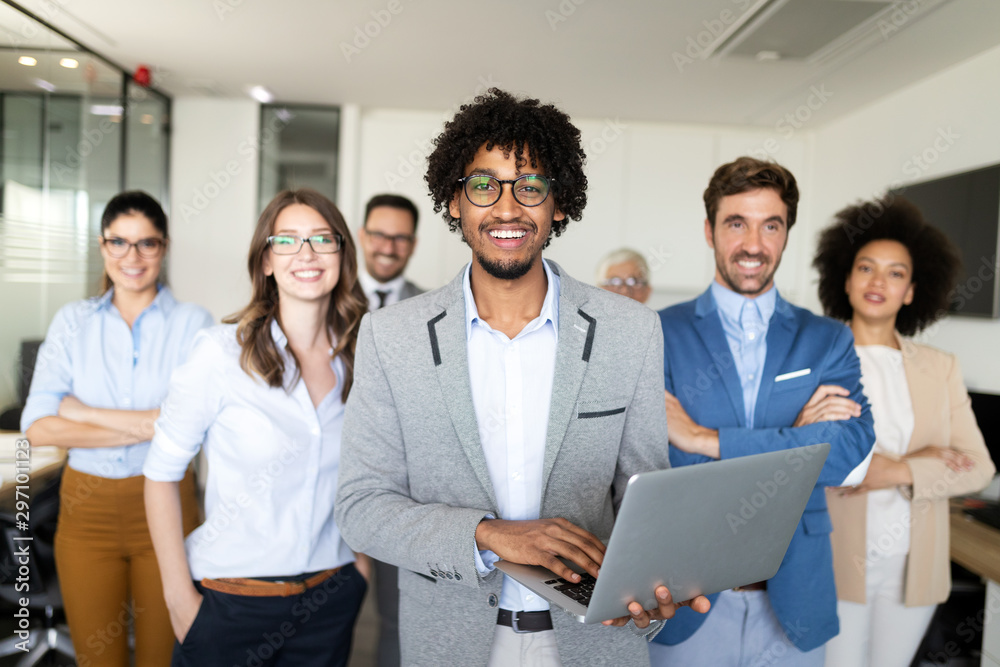 Successful team of young perspective businesspeople in office Successful team of young perspective businesspeople in office